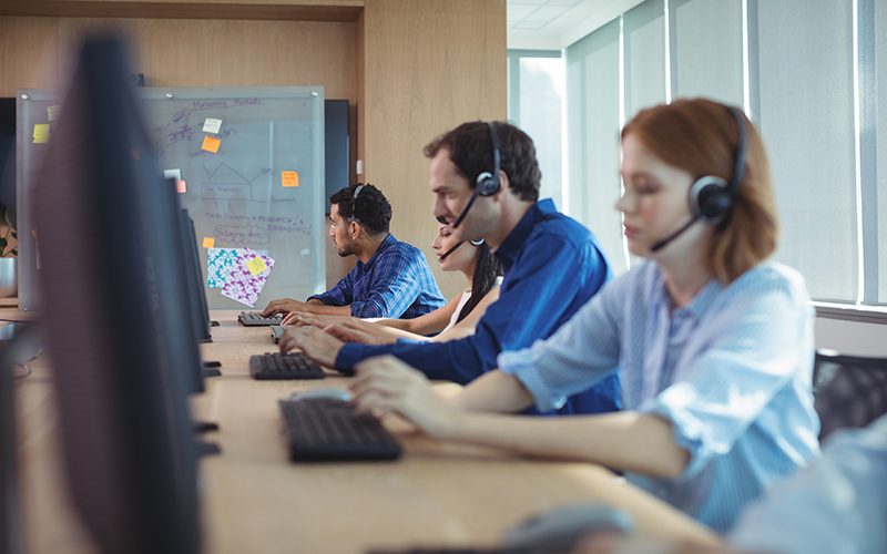 Business people working at desk in call center